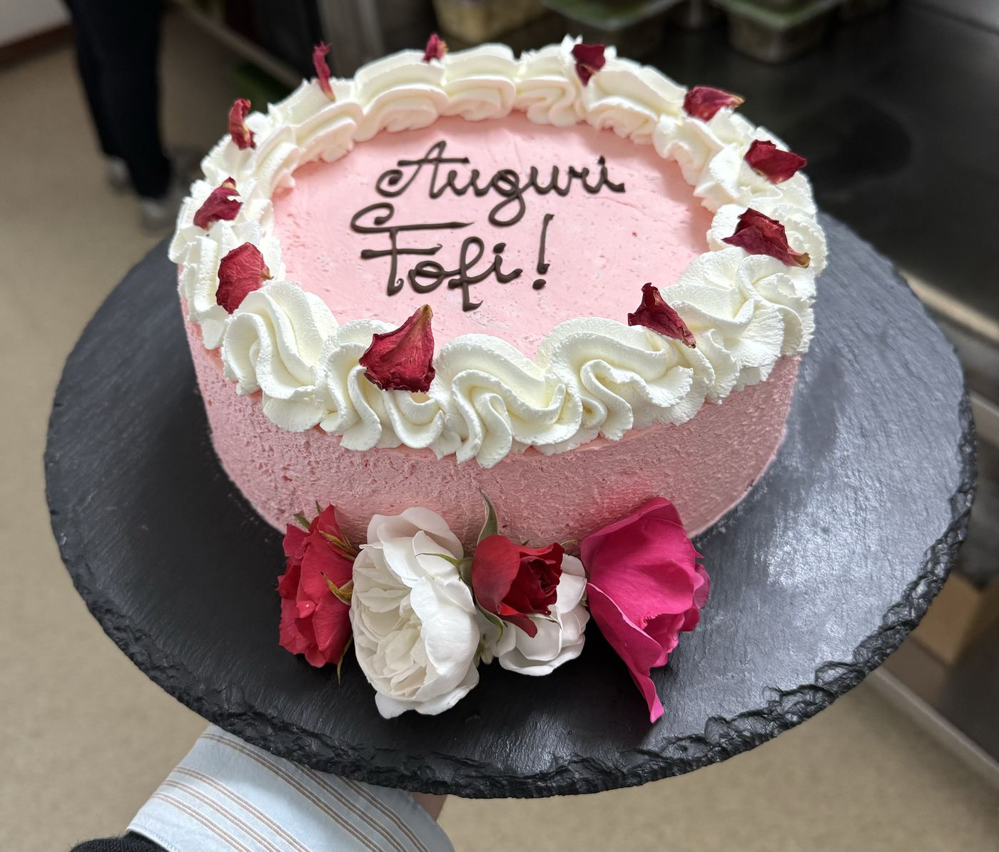 Torta rosa decorata con rose fresche